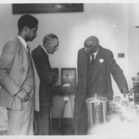 Henry Ford and two unknown individuals meeting with George Washington Carver. 